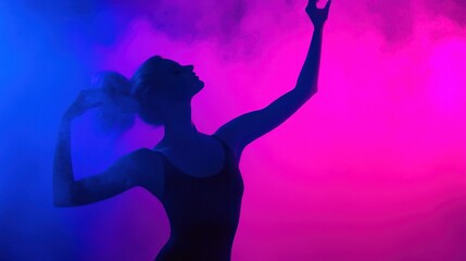 A Silhouetted Dancer Posing Gracefully with Arms Extended in the Air