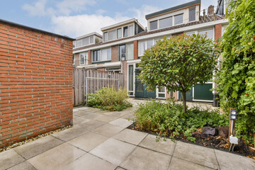 A serene backyard featuring a well-maintained garden, including a variety of plants and trees, and modern outdoor living design.