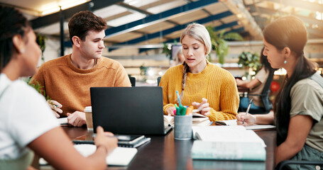 Obraz premium Team, college and book in library for education, learning and students brainstorming for thesis. Laptop, people and group in university for creative research project, writing notes or study for exam