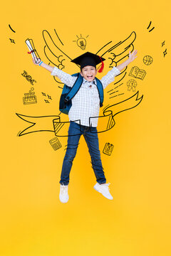 Portrait of Asian mixed race kid student wearing graduation hat jumping in yellow background with doodle drawing, education concept
