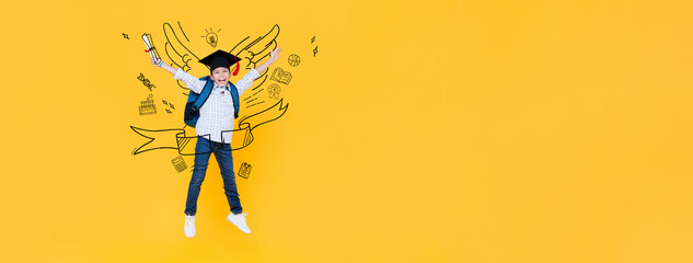 Portrait of Asian mixed race kid student wearing graduation hat jumping in yellow banner background with doodle drawing and copy space for text, education concept