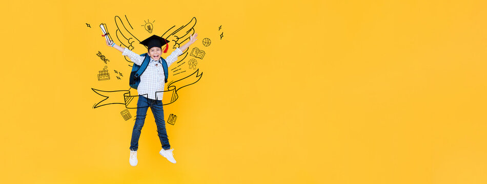 Portrait of Asian mixed race kid student wearing graduation hat jumping in yellow banner background with doodle drawing and copy space for text, education concept