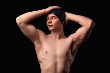 Naklejka premium Male swimmer on black background