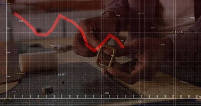 craftsman assembling metal D-ring buckle on cutting mat, showing animated line graph for technology