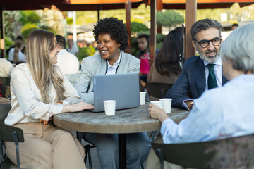 Business people having a meeting at outdoor cafe