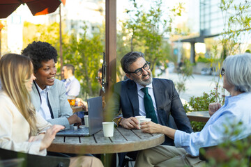 Business people having a meeting at outdoor cafe