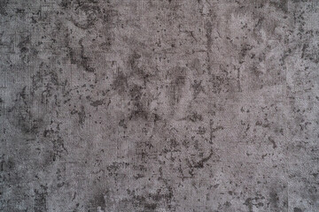 bstract gray background texture with a rough, mottled, and slightly distressed appearance, resembling concrete, plaster, or heavy fabric.