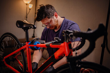 Man Focused on Bicycle Maintenance in Home Workshop