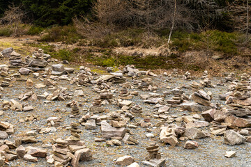 Zen stone pyramids on a rural road leading through a mountain forest in the eastern Sudetes on the border of Poland and the Czech.