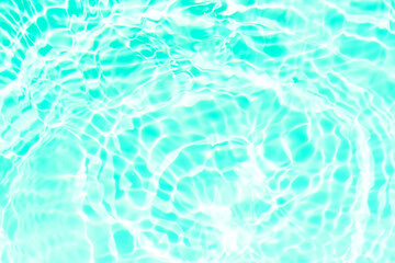 Blue water with ripples on the surface. Defocus blurred transparent blue colored clear calm water surface texture with splashes and bubbles. Water waves with shining pattern texture background.