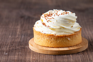Lemon tartlets with whipped cream, sprinkles and chocolate chips on white background