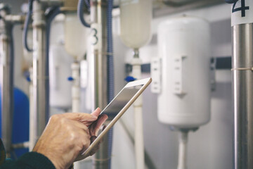 Senior maintenance engineer checking the system in the boiler room