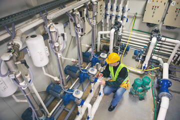 Senior maintenance engineer checking the system in the boiler room