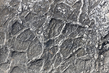 Cracked Mineral Veins on Dark Rock Surface