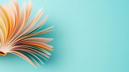 Fototapeta premium Open Book Pages Fanning Out On Blue Background