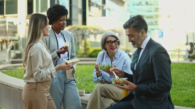 Business people enjoying lunch break together outdoors