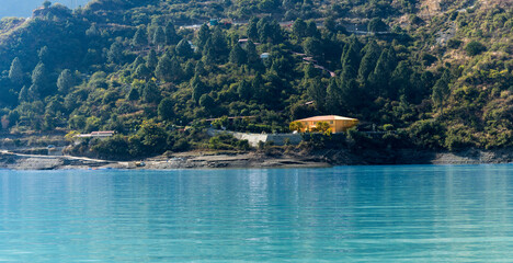 A hotel situated on the lake offers breathtaking views of the mountains behind. The serene surroundings make it an ideal getaway.