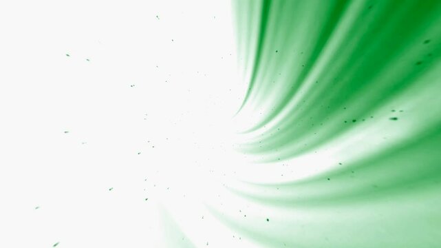 Bright green rays from the upper right side to the center on a white background with space for your own content, slowly arriving dust particles. Abstraction.