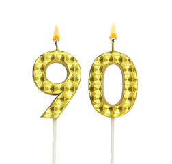 Burning gold birthday candles isolated on white background, number 90.	

