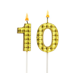 Burning gold birthday candles isolated on white background, number 10.	
