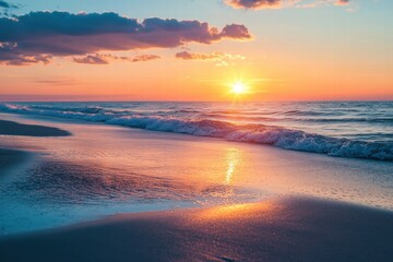 Fototapeta premium Golden hour at the beach with soft waves and vibrant sky reflections