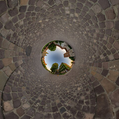 blue hole sphere or globe little planet inside grass or sand or dry ground frame background with tractor tracks