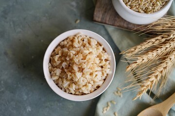 Cooked brown rice served in a bowl, selective focus