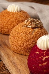 Delicious cream-filled pastries displayed on a wooden board for a tempting dessert experience