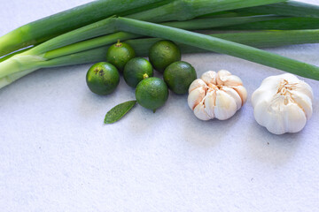Fresh Organic Garlic, Green Calamansi, and Scallions, Perfect for Healthy Food Concepts