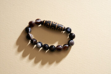 Tibetan  Eyes Dzi beads bracelet on yellow background.