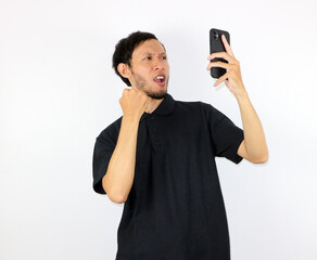Man Expressing Anger While Looking at His Mobile Phone Screen
