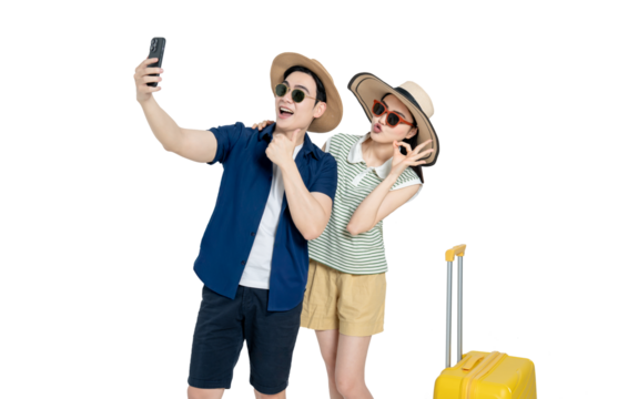 portrait of asian couple wearing travel clothes, suitcases and using phone  posing on white background