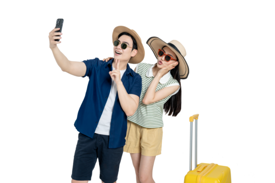 portrait of asian couple wearing travel clothes, suitcases and using phone  posing on white background