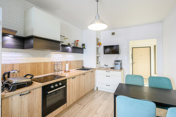 interior apartment kitchen and dining room, refectory area, cooking equipment, table furniture, stove