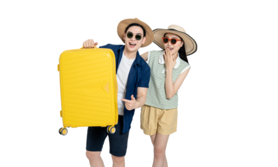 portrait of asian couple wearing travel clothes, carrying suitcases and posing on white background