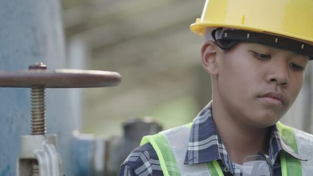 A boy is studying engineering and is using a tablet.