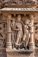 artistic carvings of hindu deities on ancient temple wall in daylight
