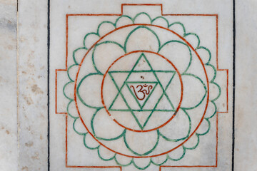 Sacred Hindu Geometric Symbol with Om on Marble from top angle