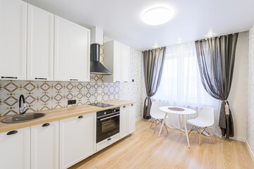 interior apartment kitchen and dining room, refectory area, cooking equipment, table furniture, stove