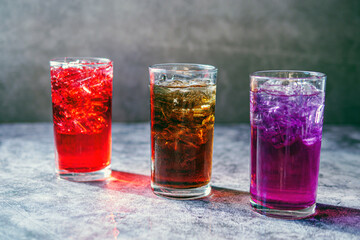 A lot of Soft drinks in colorful and flavorful glasses on the table,Glasses with sweet drinks with ice cubesv