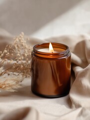 Amber jar candle mockup decorated with flowers and plants, creative design preview template for candle branding, organic scented candle with decor