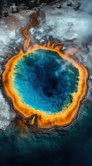 Colorful hot spring with vibrant blue center surrounded by orange and brown.