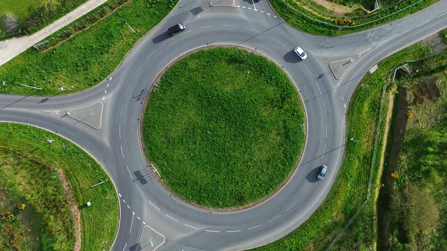 4K drone aerial of Glan Gwna roundabout with cars in motion, Caernarfon at Daytime, Wirral, UK