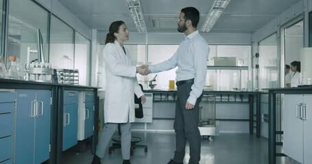 Scientist and Business man Meeting in Laboratory to Discuss results - Powered by Adobe