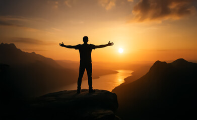 Fototapeta premium With arms open wide, a lone figure stands at cliff's edge during a glowing sunset, embodying freedom, awe, and the beauty of nature.