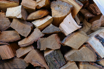 cut, stacked pieces of logs, background