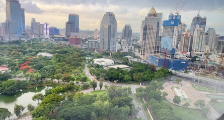 A vibrant urban landscape featuring a blend of skyscrapers and lush greenery, showcasing the harmony between nature and city life.