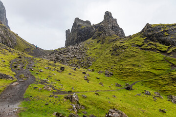 The Quiraing, Isle of Skye lush green landscapes, pure air, dramatic cliffs. A surreal trail through wild nature, perfect for trekking, silence, breathing untouched beauty, mystical rock formations.