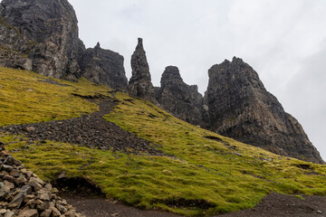 The Quiraing, Isle of Skye lush green landscapes, pure air, dramatic cliffs. A surreal trail through wild nature, perfect for trekking, silence, breathing untouched beauty, mystical rock formations.