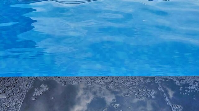 a video showing the water in a swimming pool that is blue and calm